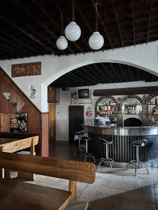 a bar with a wooden bench and bar stools at B&B Lukač in Kutina