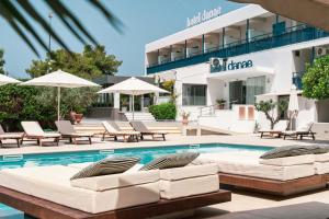 a swimming pool with lounge chairs and a hotel at Danae Hotel in Egina