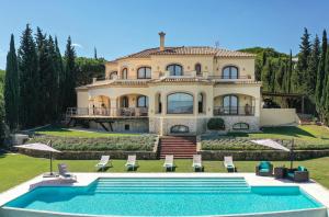 a large house with a swimming pool in front of it at Casa Ceylan Luxury 8 Bed Villa with Sea, Golf & Mountain Views in Sotogrande