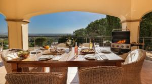 a table with food and a fireplace on a patio at Casa Ceylan Luxury 8 Bed Villa with Sea, Golf & Mountain Views in Sotogrande