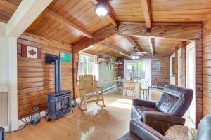 a living room with a fireplace and a stove at Cozy Lake Champlain Cottage with Private Beach! in North Hero