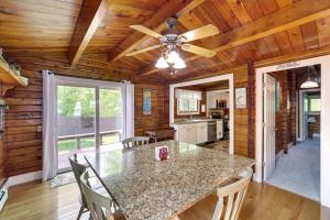 a dining room with a table and a ceiling fan at Cozy Lake Champlain Cottage with Private Beach! in North Hero