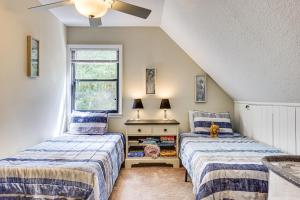a bedroom with two beds and a window at Rural Retreat! Florida Cottage with Screened Patio in Pine Bluff