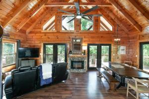 a living room with a dining table and a fireplace at Scenic Seclusion w Hot Tub View PuttPutt More in Sevierville