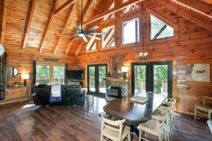 a dining room with a table and a ceiling fan at Scenic Seclusion w Hot Tub View PuttPutt More in Sevierville