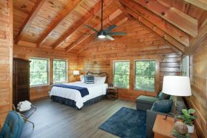 a bedroom with a bed and a ceiling fan at Scenic Seclusion w Hot Tub View PuttPutt More in Sevierville
