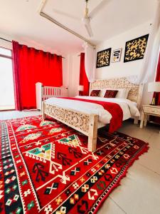 a bedroom with a bed and a colorful rug at The Casa Sultan in Kikambala +60 photos