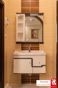 a bathroom with a sink and a mirror at سيتى للشقق المخدومة in Jeddah