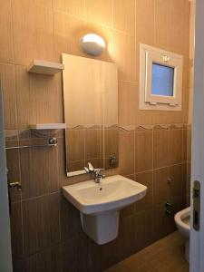 a bathroom with a sink and a mirror at Lake View Apartment in Famagusta in Mağusa