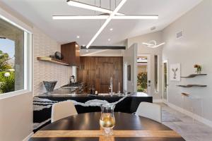 a kitchen and dining room with a table and chairs at *Condo - 490 E Via Ensenada Cir, 92264 in Palm Springs
