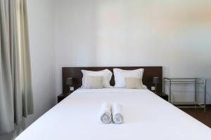 Postel nebo postele na pokoji v ubytování Kak Garden Inn