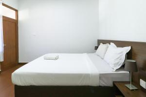 Postel nebo postele na pokoji v ubytování Kak Garden Inn