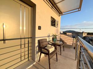 a balcony with a table and chairs and a view at Corfu Airport Sweet Studio in Ágios Rókkos