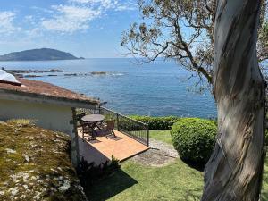 a house with a deck with a view of the ocean at Casas sobre el mar en Vigo in Vigo