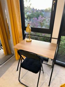 a table and a chair in front of a window at 2 Bedroom House & Parking 2 washrooms in Reading