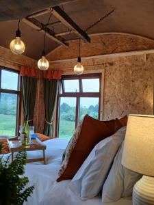 a bedroom with a large bed and a table at Little Oakhurst in Clitheroe