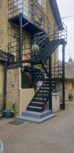 a spiral staircase on the side of a building at Lovely 3 Bedroom apartment in Reigate