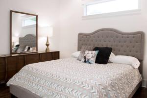 a bedroom with a large bed with a large mirror at NEW Music Icon House in East Nashville in Nashville