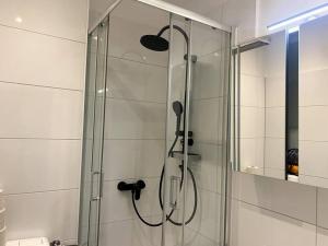 una ducha con puerta de cristal en un baño en Perfect Place, en Duisburg