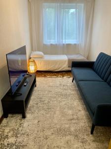 a living room with a couch and a bed at Karula Stay 1-Room Apartment in Antsla