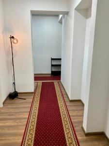 a hallway with a red rug on the floor and a lamp at Karula Stay 1-Room Apartment in Antsla