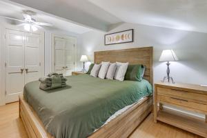 a bedroom with a large green bed with a ceiling fan at Idyllic Sea Pines Villa Walk to the Beach and More! in Hilton Head Island