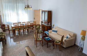 a living room with a couch and chairs and a table at Casa Meraviglia del mare in Capo dʼOrlando