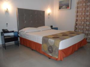 Ένα ή περισσότερα κρεβάτια σε δωμάτιο στο Hotel Calima Real