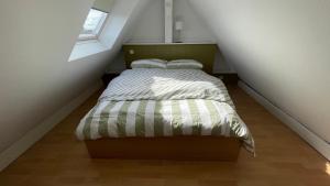 a small bedroom with a bed in a attic at Apartment über 2 Etagen nahe Messe und Stadion in Dortmund