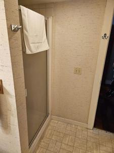 a bathroom with a shower with a towel on the door at Chester Inn in Chester