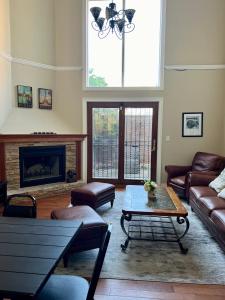 a living room with a couch and a coffee table at 4 bedroom in Best Location Parking Fireplace Back Yard Home office Pets Welcome in Chicago