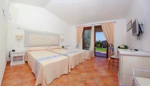 Postel nebo postele na pokoji v ubytování Hotel Costa Caddu