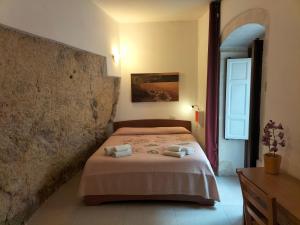 a bedroom with a bed with two towels on it at San Filippo Neri - CAMERE in Ragusa +42 photos