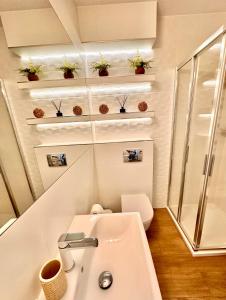 a small bathroom with a sink and a toilet at Apartament K&K Klifowa Rewal in Rewal