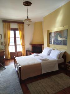 a bedroom with a large bed with white sheets at Guesthouse Filoxenia in Kastoria