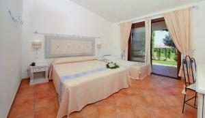 Postel nebo postele na pokoji v ubytování Hotel Costa Caddu