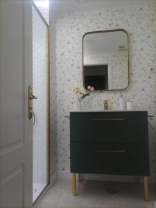 La salle de bains est pourvue d'une commode noire et d'un miroir. dans l'établissement Apartamentos Pirra - Aeropuerto Ifema, à Madrid