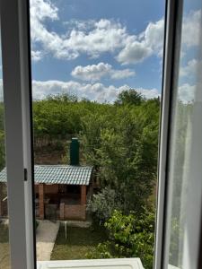 a window with a view of a picnic table at Guesthouse SANIKO in Martvili
