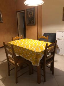 カステッラルクアートにあるIl Castelloのダイニングルームテーブル(黄色のテーブルクロス付)