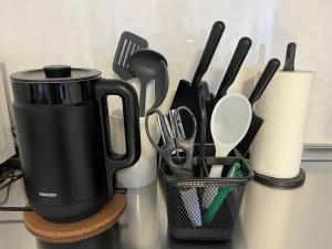 a container of utensils sitting on a counter with a cup at 嵐山 天龍の宿 New Open一棟貸切Private Villa,Arashiyama Central,Togetsu bridge 徒歩5min in Shimo saga