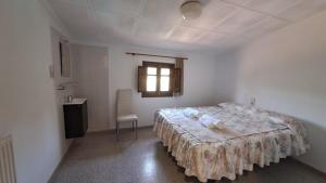 a bedroom with a large bed and a window at Rural Sant Llop in Tordera