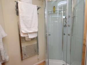 a bathroom with a shower and a glass shower stall at 1 Bed in Biggar 75414 in Biggar