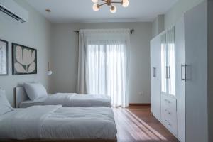 Postel nebo postele na pokoji v ubytování Settle Inn Sodic Villette Apartment