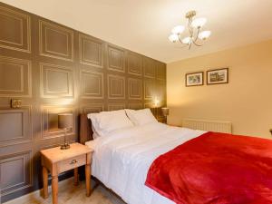 a bedroom with a large bed with a red blanket at 1 Bed in Waterfall 89733 in Waterhouses
