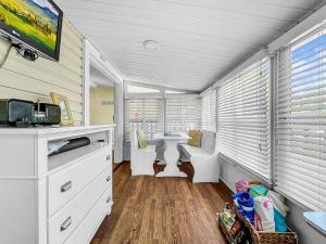 a bathroom with a sink and a desk and a window at Island Hideaway steps to beach dock Bridge St in Bradenton Beach