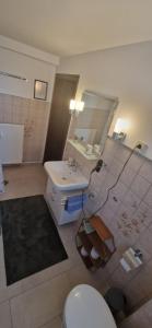 a bathroom with a toilet and a sink and a mirror at Ferienwohnung Gisela in Bückeburg
