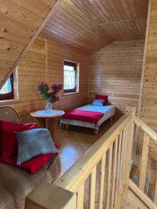 a log cabin with a bed and a table at Roby 45 in Mrzeżyno