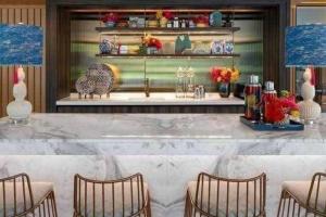 a bar with chairs and a counter with vases at PRIME TOWN Phuket Resort & Wellness in Ban Rangeng