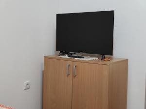 a flat screen tv on top of a wooden cabinet at Studio Elizabeta in Soko Banja