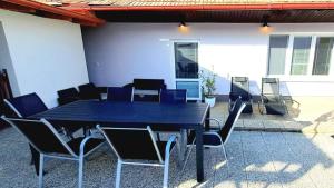 a black table and chairs on a patio at Na Jezérkách in Vacenovice